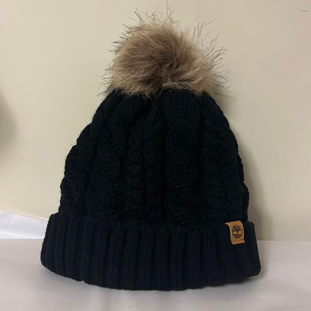 Timberland black cable knit, fleece lined hat with furry Pom on top, new